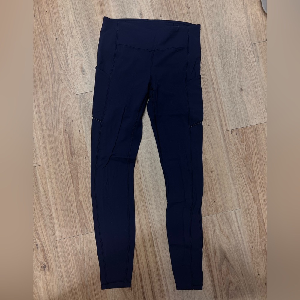 Lululemon dark navy size 6 leggings with side pockets and back zipper.